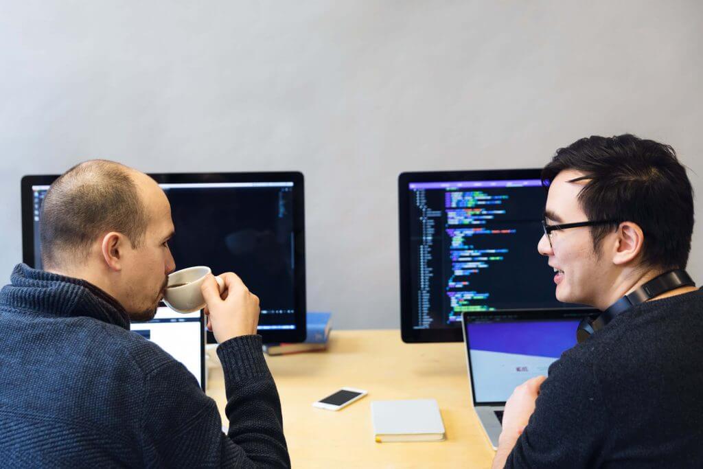 two software developers discussing coding